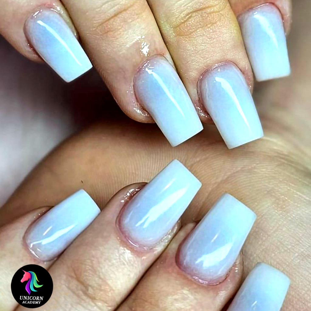 Unicorn Academy | Milky white gel-acrylic nail extensions with a glossy finish.