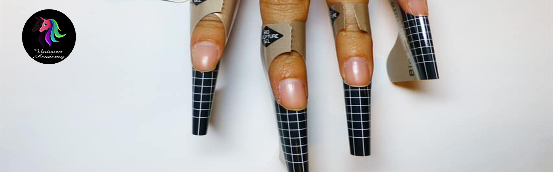 Close-up image of a hand with disposable nail forms placed underneath natural nails, ready for acrylic or gel application.